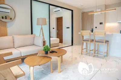 a living room with a couch and a table and chairs at Alfa Bangsar by Plush in Kuala Lumpur
