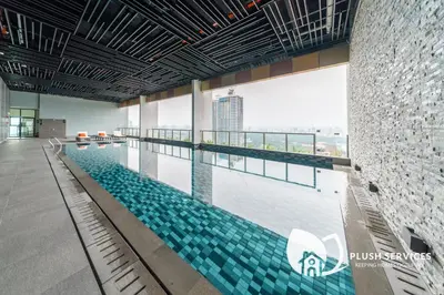 a large swimming pool in a large building at Alfa Bangsar by Plush in Kuala Lumpur