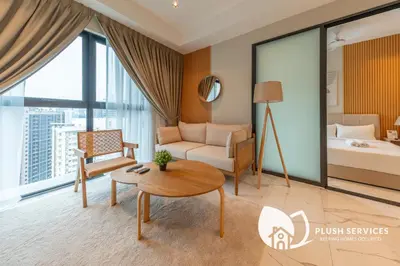 a living room with a couch and a table at Alfa Bangsar by Plush in Kuala Lumpur
