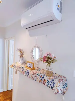 a room with a shelf with flowers and a mirror at Newly Reno Wisma Cosway Pavilion KLCC Bukit Bintang in Kuala Lumpur