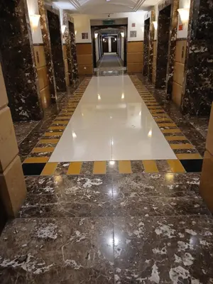 a hallway with a marble floor in a building at Family Empire Suites At Times Square in Kuala Lumpur
