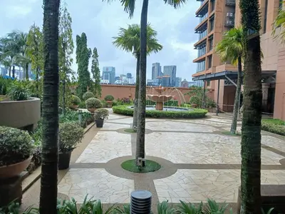 a courtyard with palm trees in a building at Family Empire Suites At Times Square in Kuala Lumpur