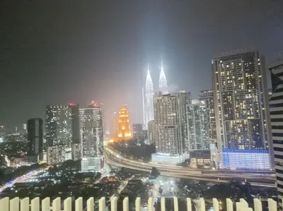 a night view of a city with tall buildings at COL 171A Modern Balcony KLCC View & Infinity Pool in Kuala Lumpur