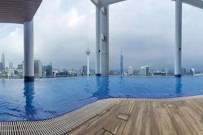 a large swimming pool with a view of the city at COL 171A Modern Balcony KLCC View & Infinity Pool in Kuala Lumpur