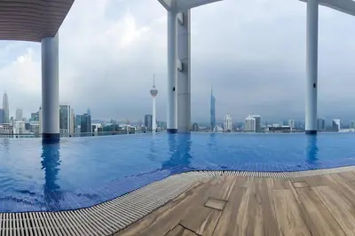 a large swimming pool with a view of the city at COL 171B KLCC Balcony View & Infinity Pool in Kuala Lumpur