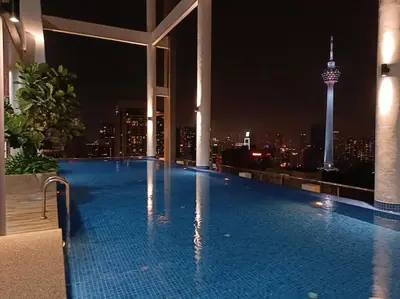 a swimming pool on top of a building with a city skyline at COL 171B KLCC Balcony View & Infinity Pool in Kuala Lumpur