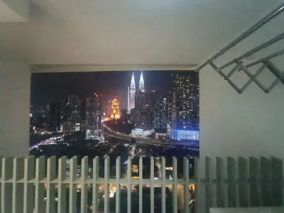 a view of a city skyline from a window at COL 171B KLCC Balcony View & Infinity Pool in Kuala Lumpur