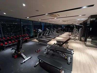 a gym with a row of treadmills and machines at COL 23a8A Morden KLCC View Studio in Kuala Lumpur