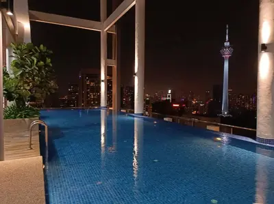 a swimming pool on the roof of a building with a city skyline at COL 23a8A Morden KLCC View Studio in Kuala Lumpur