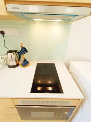 a kitchen counter with a stove in a kitchen at COL 23a8A Morden KLCC View Studio in Kuala Lumpur