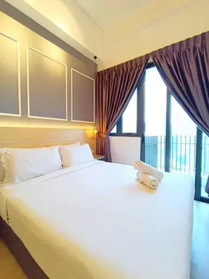 a large white bed with a teddy bear sitting on it at COL 23a8B Modern KLCC View Studio in Kuala Lumpur