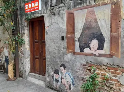 a painting on the side of a building with a window at Cozy Idaman Robertson Suite Balcony in Kuala Lumpur