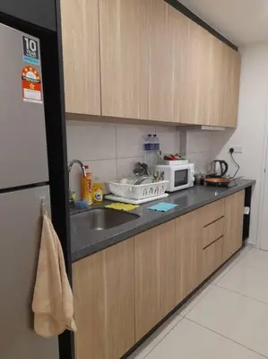 a kitchen with a sink and a microwave at Cozy Idaman Robertson Suite Balcony in Kuala Lumpur