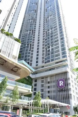 a tall building with a purple sign in front of it at Cozy Idaman Robertson Suite Balcony in Kuala Lumpur