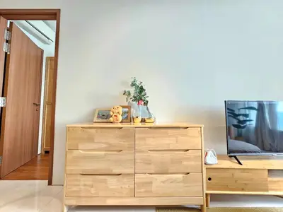 a wooden dresser with a tv on top of it at The Sky Residence KLCC by AsianHost in Kuala Lumpur