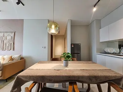 a kitchen and dining room with a table in a room at The Sky Residence KLCC by AsianHost in Kuala Lumpur