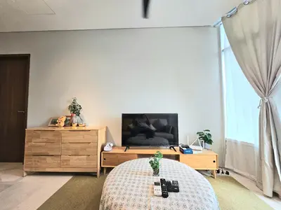 a bedroom with a bed and a tv and a dresser at The Sky Residence KLCC by AsianHost in Kuala Lumpur