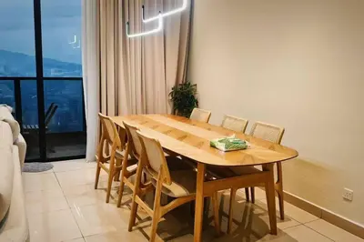 a wooden table and chairs in a room with a window at 4B3R Lux Penthouse Astoria Ampang in Kuala Lumpur