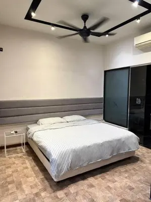 a bedroom with a bed with a ceiling fan at Expressionz Professional Suites Studio in Kuala Lumpur