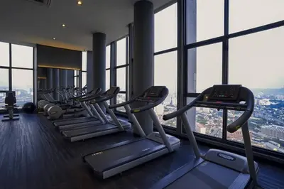 a gym with a row of tread machines in a building at Expressionz Professional Suites Studio in Kuala Lumpur