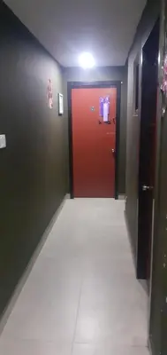 a hallway with a red door and a white tile floor at STAY WITH DAy CAUCON in Kuala Lumpur
