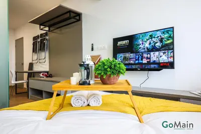 a table with a coffee maker on top of a bed at Skypool with KLCC View - KL Sentral Riveria City Suite Near KL City Centre KLCC in Kuala Lumpur