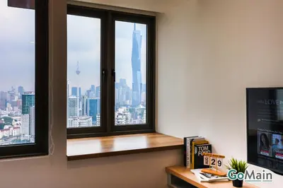 a room with a window with a view of the city at Skypool with KLCC View - KL Sentral Riveria City Suite Near KL City Centre KLCC in Kuala Lumpur
