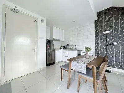 a kitchen with a table and chairs in a room at Arte Mont Kiara Wonder 2BR Suites in Kuala Lumpur