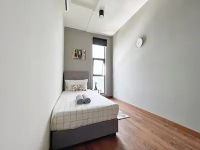 a bedroom with a bed and a window at Arte Mont Kiara Wonder 2BR Suites in Kuala Lumpur