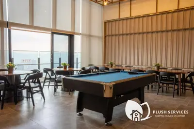a pool table in a room with tables and chairs at Agile Bukit Bintang KLCC by Plush in Kuala Lumpur
