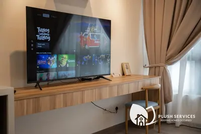 a flat screen tv sitting on top of a wall at Agile Bukit Bintang KLCC by Plush in Kuala Lumpur