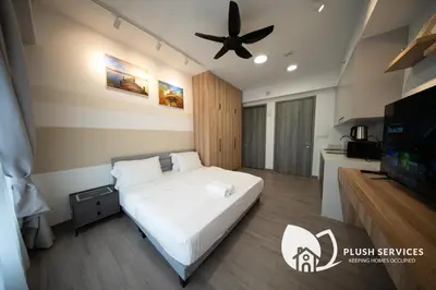 a bedroom with a bed and a ceiling fan at Agile Bukit Bintang KLCC by Plush in Kuala Lumpur