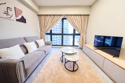 a living room with a couch and a tv at Agile Bukit Bintang KLCC by Plush in Kuala Lumpur