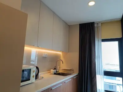 a kitchen with a sink and a microwave at Fahrenheit 88 in Kuala Lumpur