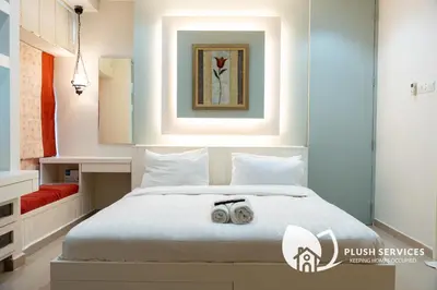 a bedroom with a bed with two shoes on it at Parkview KLCC, Bukit Bintang in Kuala Lumpur