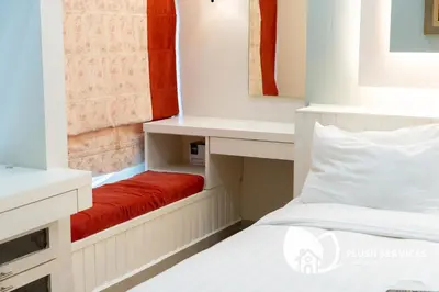 a small room with a bed and a red bench at Parkview KLCC, Bukit Bintang in Kuala Lumpur
