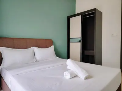 a white bed with two rolled towels on it at Trion Residence Kuala Lumpur by Luxe in Kuala Lumpur