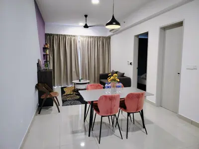 a dining room and living room with a table and chairs at Trion Residence Kuala Lumpur by Luxe in Kuala Lumpur