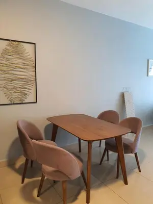 a wooden table and chairs in a room at Maxim Citylights Sentul in Kuala Lumpur