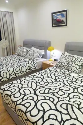 two beds sitting next to each other in a room at 1Min Pavilion Bukit Bintang KLCC Wisma Cosway in Kuala Lumpur