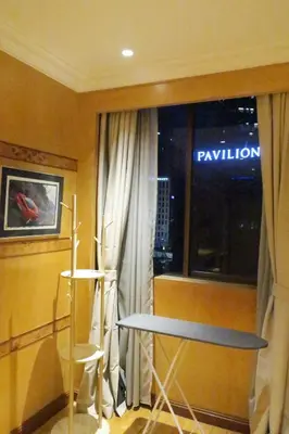 a room with a window with a table and a sign at 1Min Pavilion Bukit Bintang KLCC Wisma Cosway in Kuala Lumpur