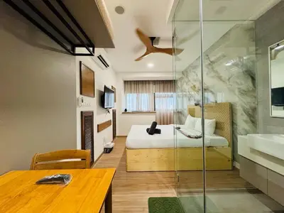 a bedroom with a bed and a table and a sink at Riveria City By Dream stay in Kuala Lumpur