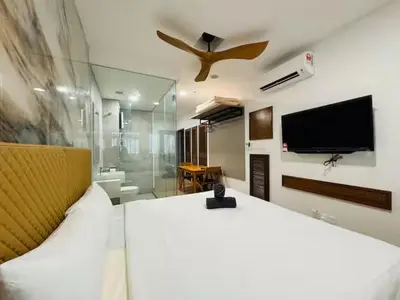 a bedroom with a large bed and a tv on the wall at Riveria City By Dream stay in Kuala Lumpur