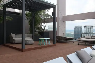 a rooftop patio with chairs and tables on a building at Riveria City By Dream stay in Kuala Lumpur
