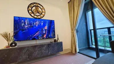 a living room with a large flat screen tv on a wall at The Atrium Ampang KLCC City , 55000Jalan Ampang Hilir, Taman U Thant KLCC in Kuala Lumpur