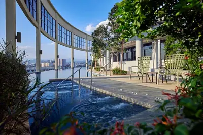 a swimming pool with a table and chairs on a building at The Atrium Ampang KLCC City , 55000Jalan Ampang Hilir, Taman U Thant KLCC in Kuala Lumpur