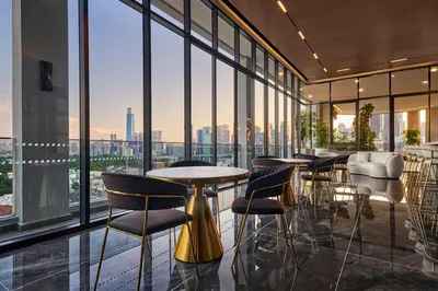 a restaurant with tables and chairs in a room with windows at The Atrium Ampang KLCC City , 55000Jalan Ampang Hilir, Taman U Thant KLCC in Kuala Lumpur