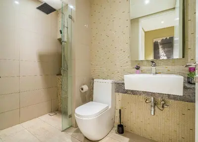 a bathroom with a toilet and a sink and a mirror at YippieeAnggunHomestay in Kuala Lumpur