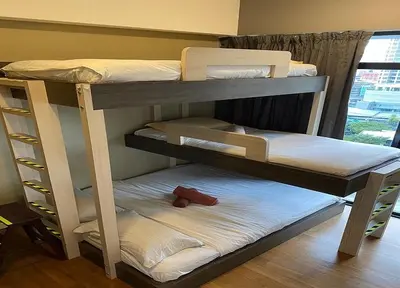two bunk beds in a room next to a window at YippieeAnggunHomestay in Kuala Lumpur