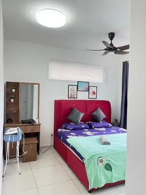 a bedroom with a red bed and a desk at Cozy Kenwingston Platz KL 2-5 Pax2BR&2BR PakinNetf 4305A in Kuala Lumpur